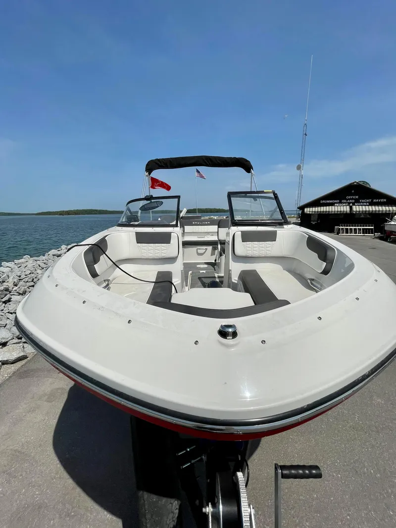 Slide: The Image of 2021 Bayliner VR5 boat docked by the water on a sunny day. - 10