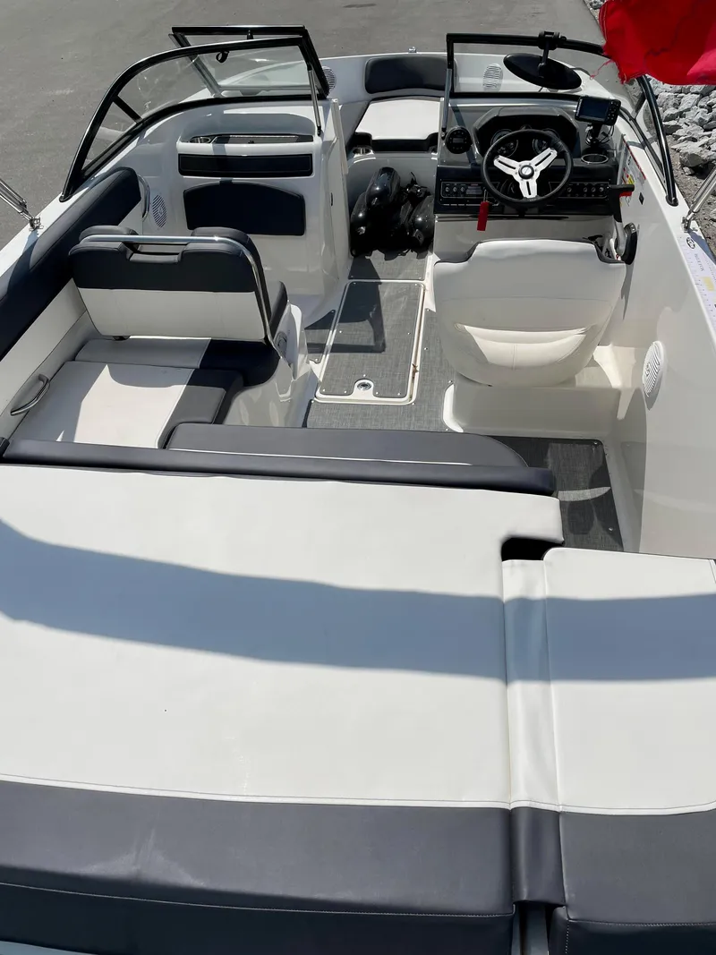 Slide: The Image of 2021 Bayliner VR5 boat interior with seating and steering wheel, viewed from above. - 13