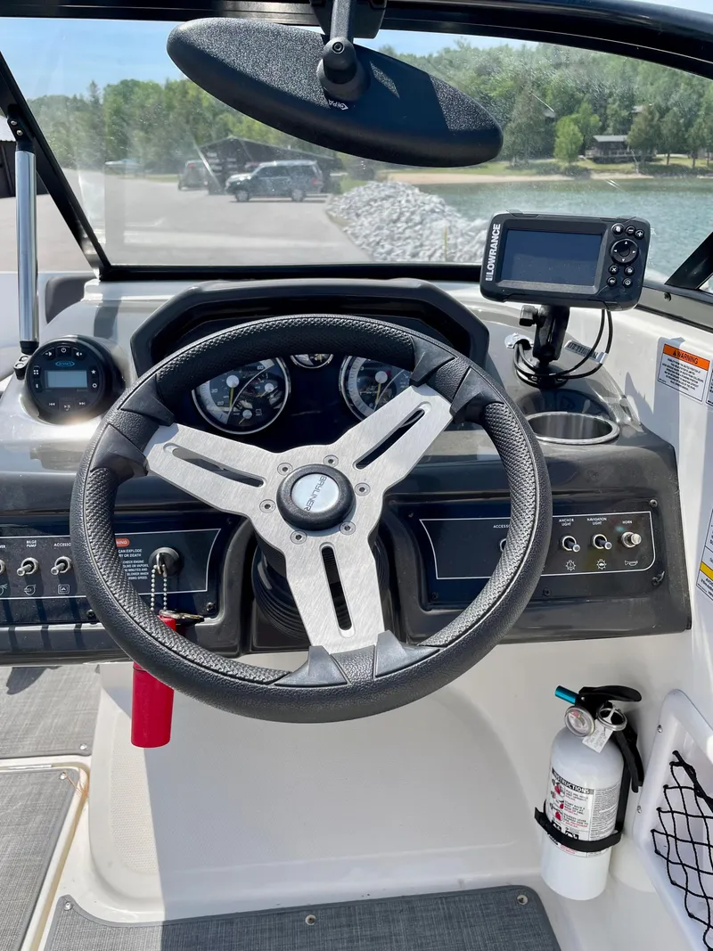 Slide: The Image of 2021 Bayliner VR5 boat dashboard with steering wheel and navigation system. - 15
