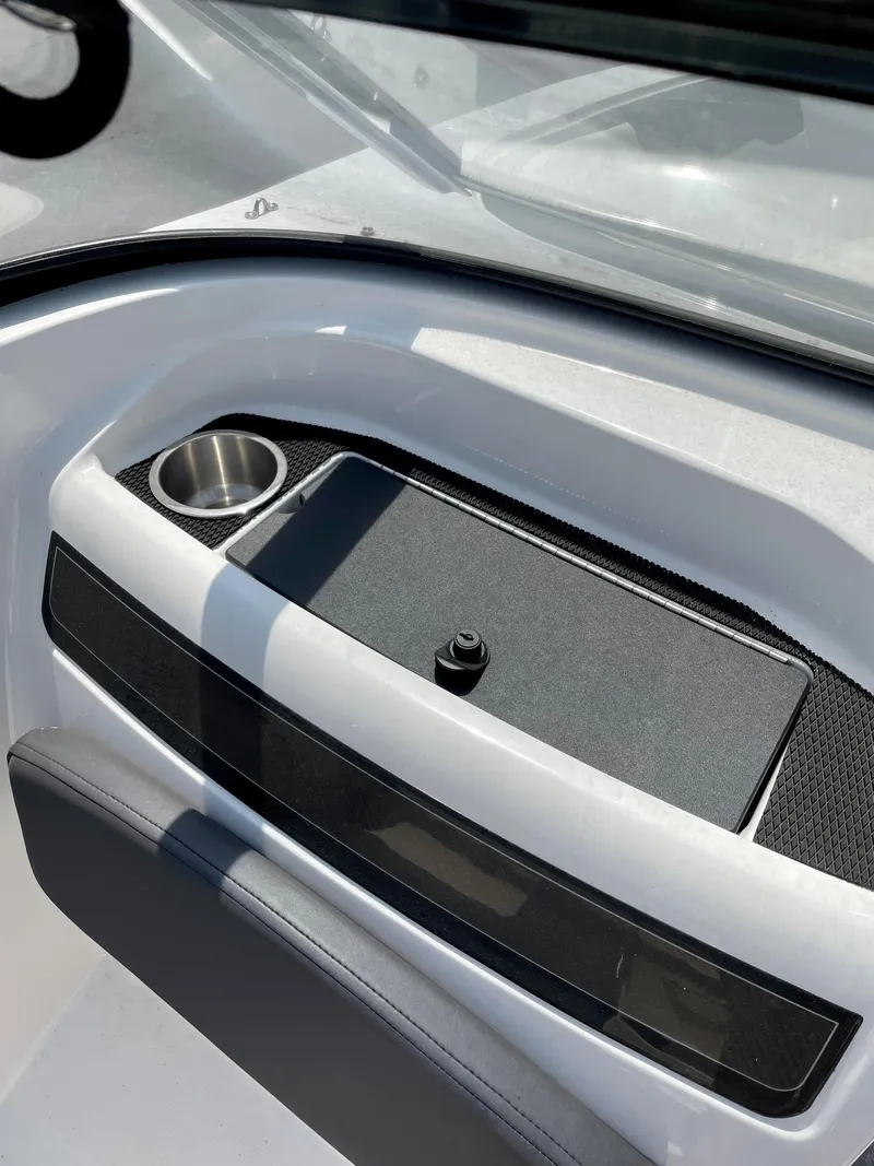 Slide: The Image of 2021 Bayliner VR5 boat interior with cup holder and storage compartment. - 16