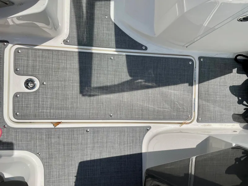 Slide: The Image of Bayliner VR5 2021 boat deck with gray textured flooring and white trim. - 20