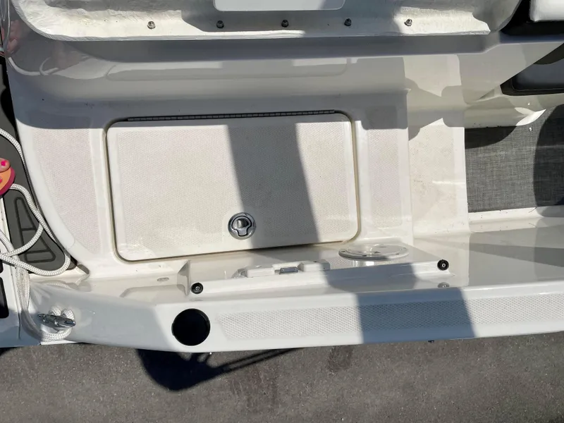 Slide: The Image of 2021 Bayliner VR5 boat deck with storage compartment and cup holder. - 21