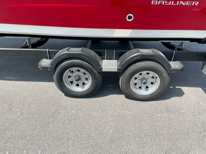 Slide: The Image of 2021 Bayliner VR5 boat trailer with dual wheels on asphalt. - 5