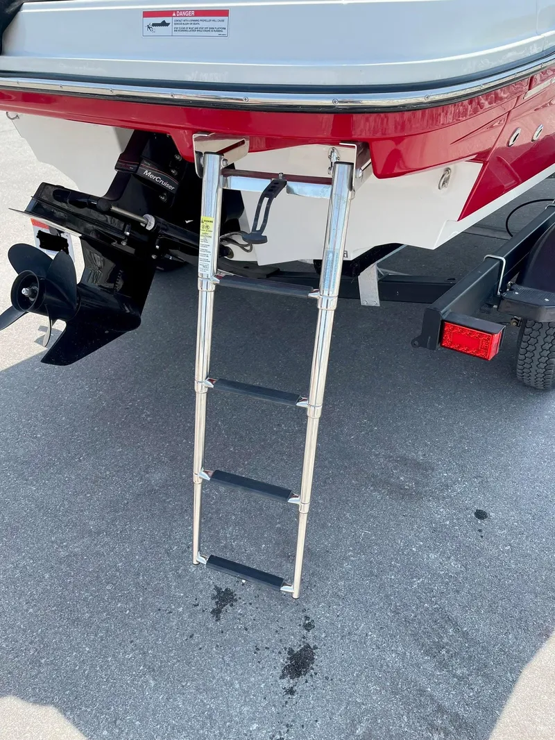 Slide: The Image of 2021 Bayliner VR5 boat with extended swim ladder and visible outboard motor. - 6