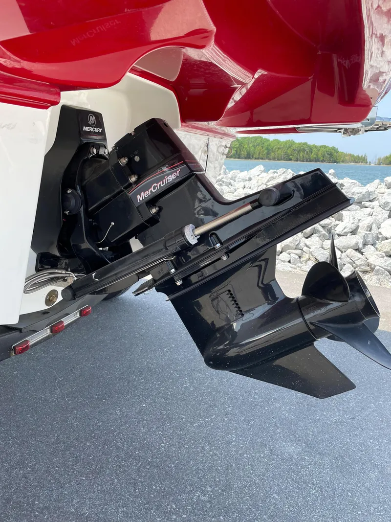 Slide: The Image of 2021 Bayliner VR5 boat with MerCruiser outboard engine, docked near rocky shoreline. - 8