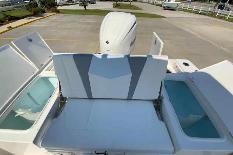 Slide: The Image of 2024 Robalo 246 Cayman boat with rear seating and storage compartments. - 10