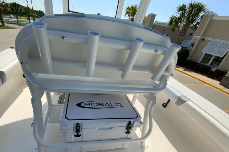 Slide: The Image of 2024 Robalo 246 Cayman boat interior with rod holders and storage compartment. - 11