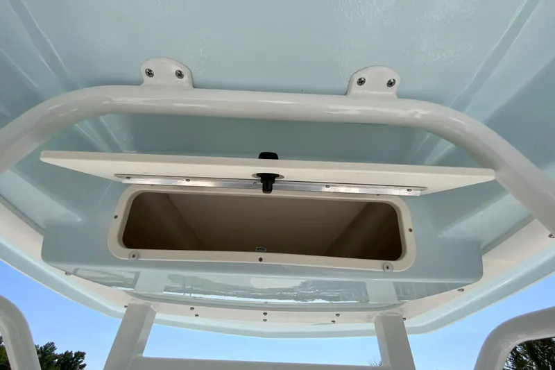 Slide: The Image of 2024 Robalo 246 Cayman boat storage compartment with open hatch. - 17