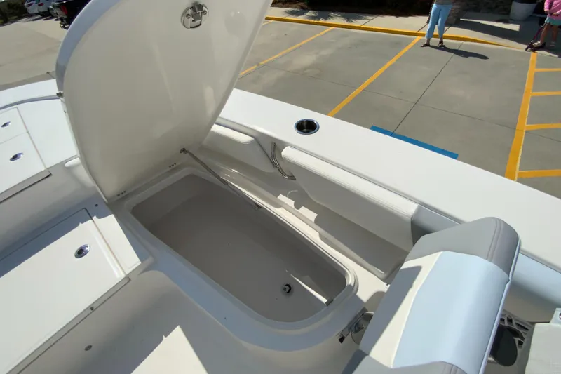 Slide: The Image of 2024 Robalo 246 Cayman boat storage compartment with open lid. - 25