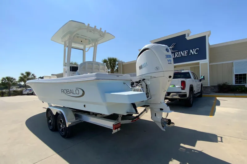 Slide: The Image of 2024 Robalo 246 Cayman boat on trailer outside Marine NC dealership. - 4