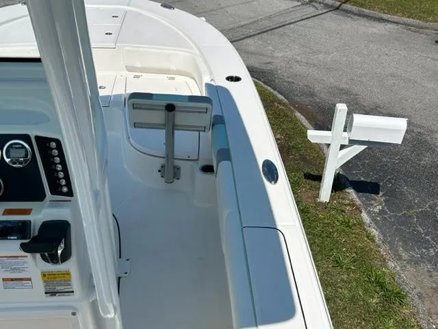 Slide: The Image of 2024 Robalo 246 Cayman boat interior, white deck, control panel, and seating area. - 9