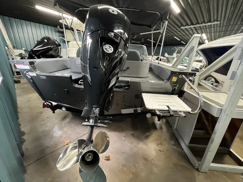 Slide: The Image of 2023 MirroCraft 176 Dual Impact boat with outboard motor in storage facility. - 3
