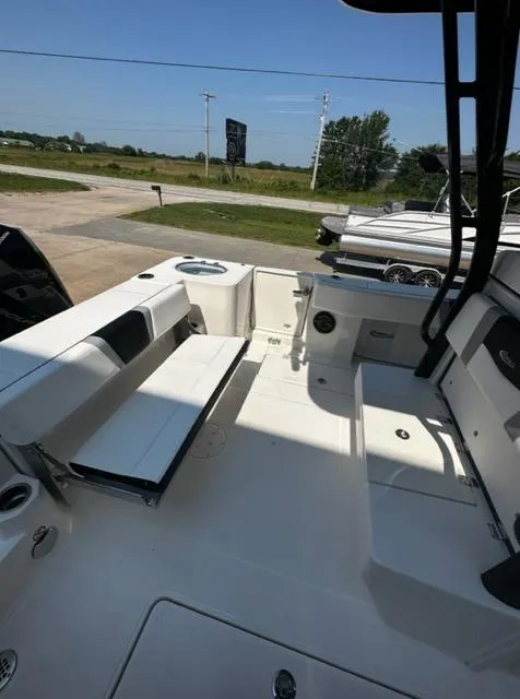 Slide: The Image of 2023 Robalo R270 boat interior with white seating and storage compartments. - 11