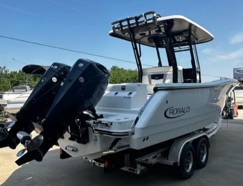 Slide: The Image of 2023 Robalo R270 boat with dual outboard engines on a trailer. - 3