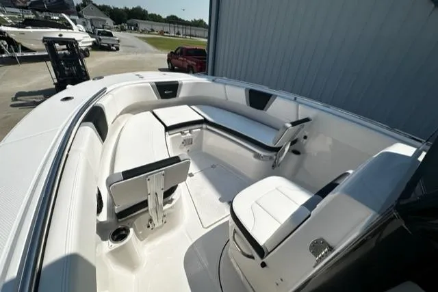 Slide: The Image of 2023 Robalo R270 boat interior with white seating and storage compartments. - 7