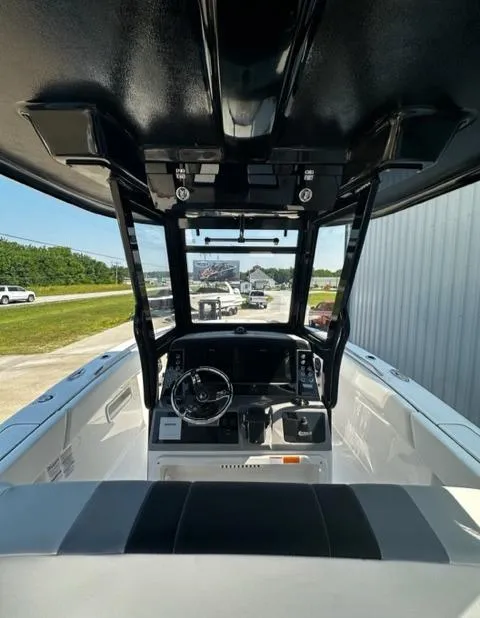 Slide: The Image of 2023 Robalo R270 boat cockpit with steering wheel and controls. - 8
