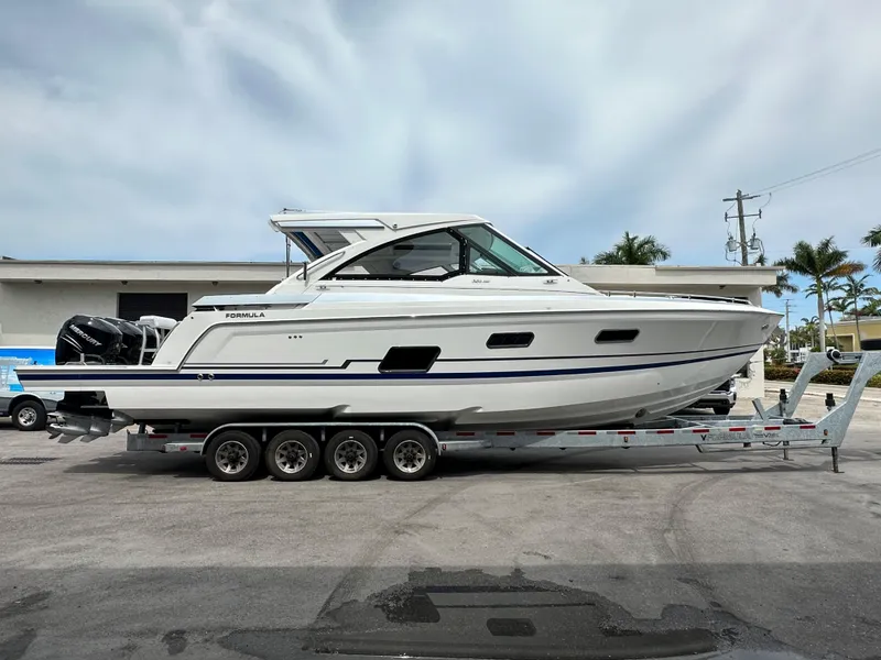 Slide: The Image of 2021 Formula 380 Super Sport Crossover OB docked at marina under clear blue sky. - 1