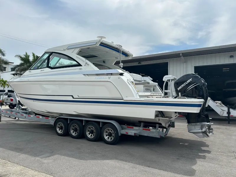 Slide: The Image of 2021 Formula 380 SSC boat on a trailer with Mercury outboard engines. - 4