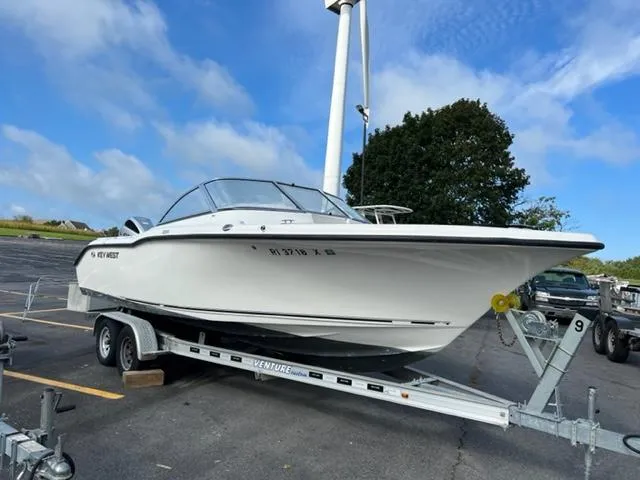 Slide: The Image of 2018 Key West 239 DFS boat on a trailer in a parking lot. - 2