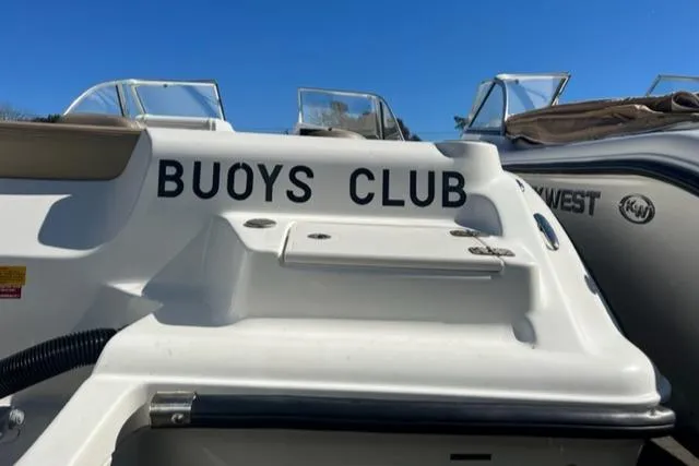 Slide: The Image of 2018 Key West 239 DFS boat with Buoys Club text on the stern. - 9