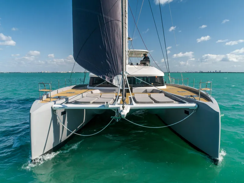 Slide: The Image of 2020 Lagoon SEVENTY 7 catamaran sailing on turquoise waters under clear skies. - 14