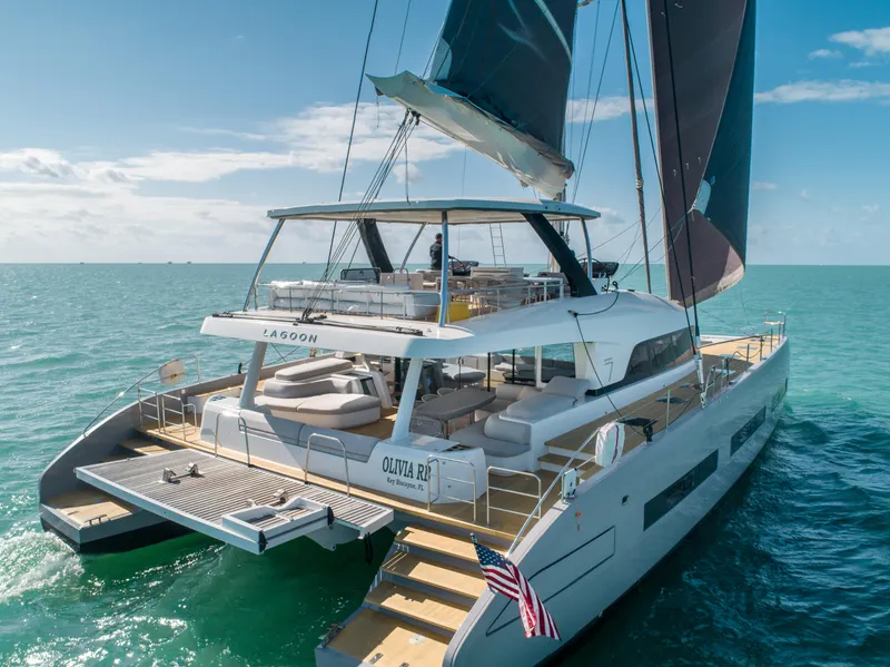 Slide: The Image of 2020 Lagoon SEVENTY 7 catamaran sailing on clear blue ocean waters. - 15