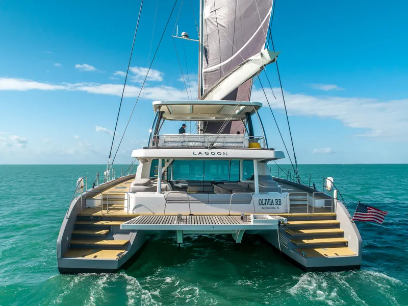 Slide: The Image of 2020 Lagoon SEVENTY 7 catamaran sailing on open sea under clear blue sky. - 24