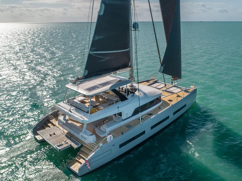 Slide: The Image of 2020 Lagoon SEVENTY 7 catamaran sailing on open sea, featuring sleek design and spacious deck. - 29