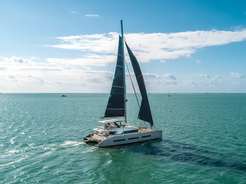 Slide: The Image of 2020 Lagoon SEVENTY 7 catamaran sailing on open sea under clear blue sky. - 3