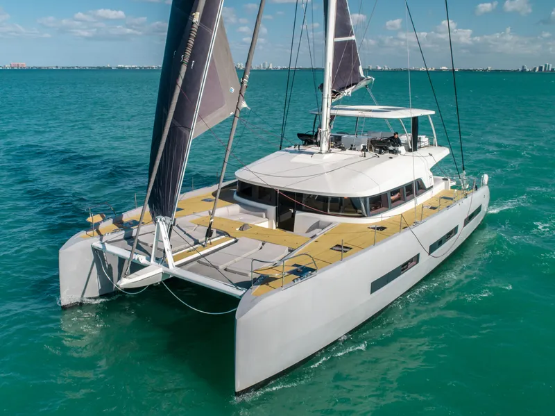 Slide: The Image of 2020 Lagoon SEVENTY 7 catamaran sailing on turquoise waters under a clear sky. - 30
