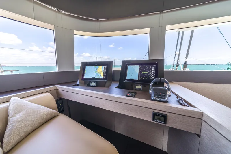 Slide: The Image of Interior helm of 2020 Lagoon SEVENTY 7 yacht with navigation screens and ocean view. - 42