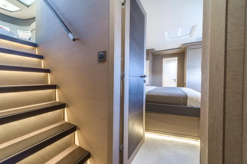 Slide: The Image of Interior of 2020 Lagoon SEVENTY 7 yacht, featuring modern staircase and luxurious bedroom. - 47