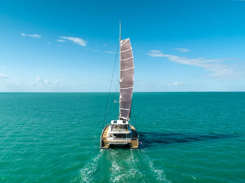 Slide: The Image of 2020 Lagoon SEVENTY 7 catamaran sailing on turquoise ocean under clear blue sky. - 5