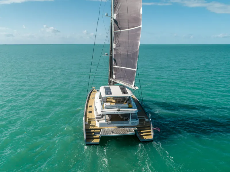 Slide: The Image of 2020 Lagoon SEVENTY 7 catamaran sailing on turquoise ocean waters. - 6
