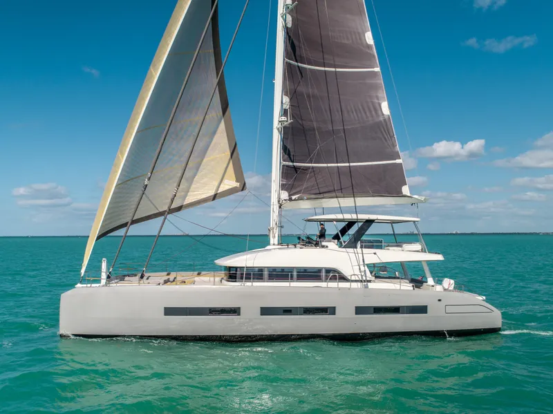 Slide: The Image of 2020 Lagoon SEVENTY 7 yacht sailing on turquoise waters under clear blue skies. - 8