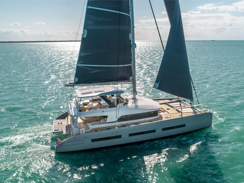 Slide: The Image of 2020 Lagoon SEVENTY 7 yacht sailing on clear blue ocean waters. - 9