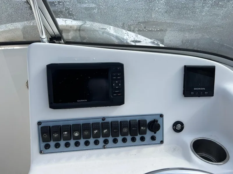 Slide: The Image of Control panel of a 2017 Key West 239 DFS boat with Garmin and Honda displays. - 7