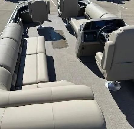 Slide: The Image of Interior of 2023 Sun Tracker Sportfish 24 XP3 pontoon boat with beige seating. - 2