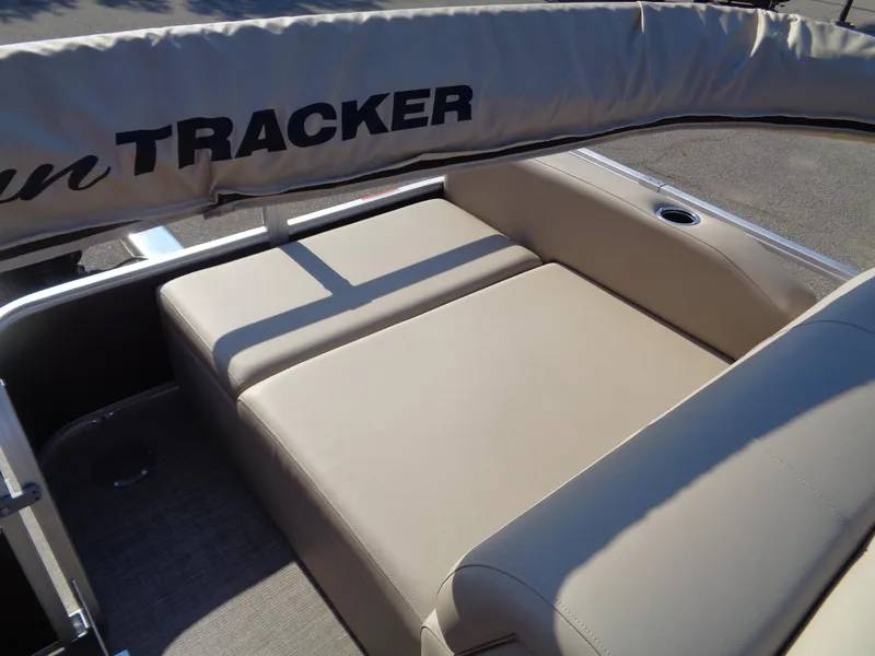 Slide: The Image of 2023 Sun Tracker Sportfish 24 XP3 boat with beige seating and canopy. - 12
