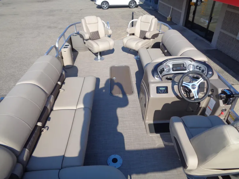 Slide: The Image of 2023 Sun Tracker Sportfish 24 XP3 pontoon boat interior with beige seating and steering console. - 8