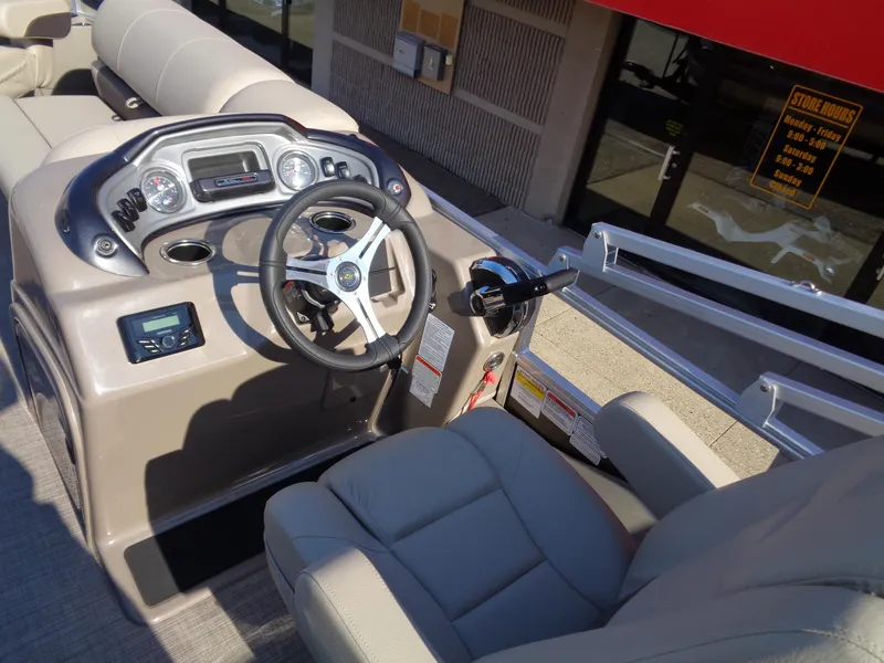 Slide: The Image of 2023 Sun Tracker Sportfish 24 XP3 boat cockpit with steering wheel and control panel. - 9