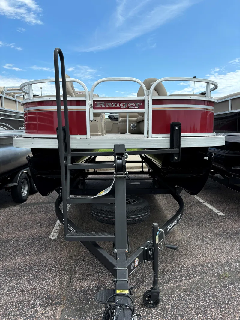 Slide: The Image of 2023 Ranger Reata 200F pontoon boat on a trailer, rear view. - 1