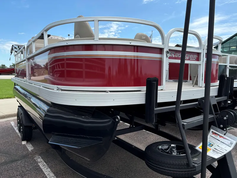 Slide: The Image of 2023 Ranger Reata 200F pontoon boat in red on a trailer. - 2
