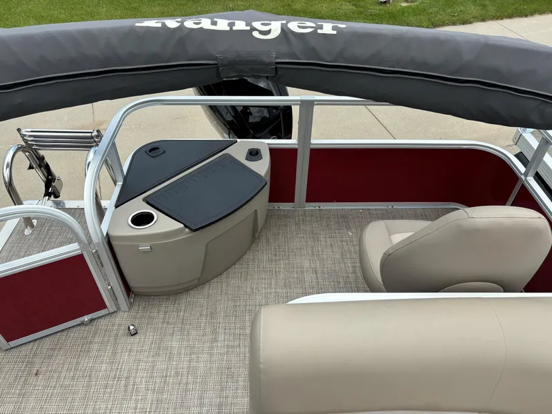 Slide: The Image of 2023 Ranger Reata 200F boat interior with beige seats and red paneling. - 7