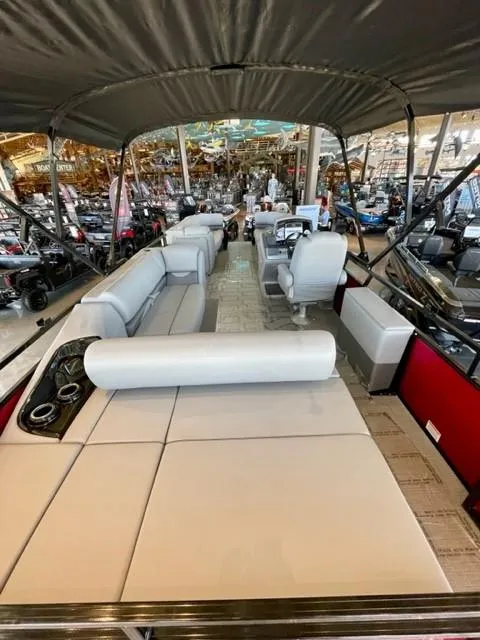 Slide: The Image of 2023 Regency 250 DL3 pontoon boat with spacious seating and canopy. - 10