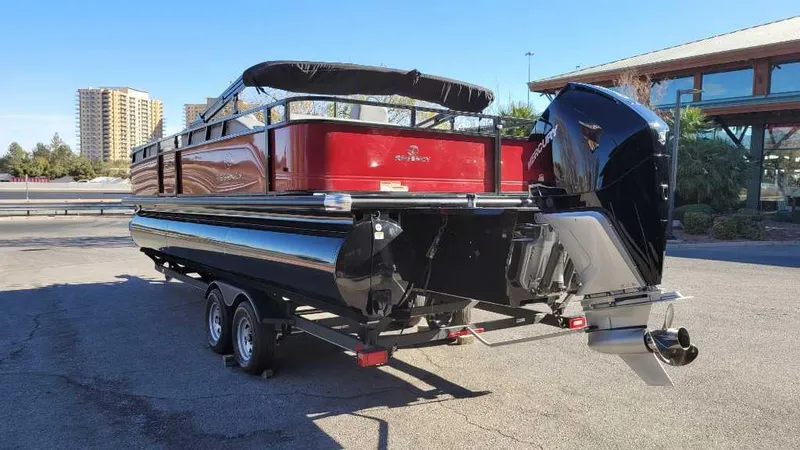 Slide: The Image of 2023 Regency 250 DL3 pontoon boat with outboard motor on trailer. - 5