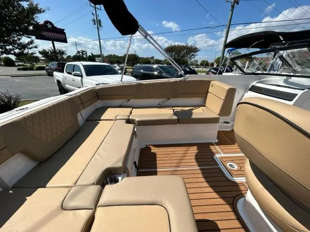 Slide: The Image of 2024 Bayliner VR4 boat interior with tan seating and teak flooring. - 13