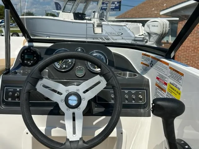 Slide: The Image of 2024 Bayliner VR4 boat dashboard and steering wheel. - 14