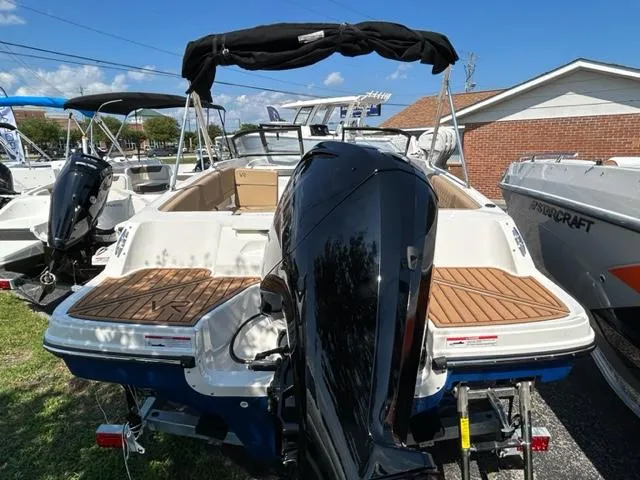 Slide: The Image of 2024 Bayliner VR4 boat with outboard motor, rear view, docked on trailer. - 2