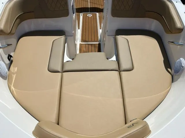 Slide: The Image of 2024 Bayliner VR4 boat with tan cushioned seating and wooden deck. - 6